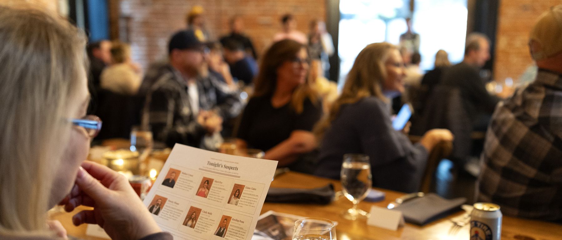 Guests seated at long tables during a Playhaus murder mystery
